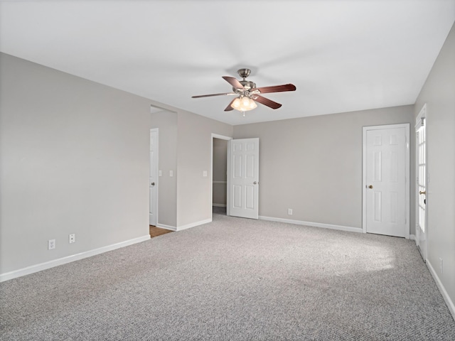 empty room with ceiling fan and carpet floors