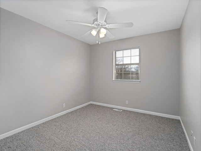 carpeted spare room with ceiling fan