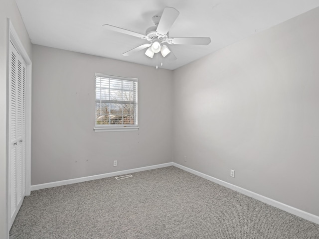 unfurnished bedroom featuring carpet flooring, a closet, and ceiling fan