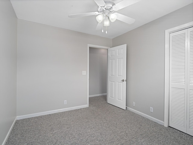 unfurnished bedroom with carpet floors, a closet, and ceiling fan