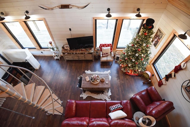 living room with wood walls, wood-type flooring, and a fireplace