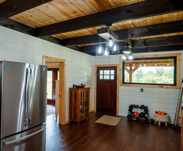 foyer entrance with beam ceiling, dark hardwood / wood-style floors, plenty of natural light, and wood walls