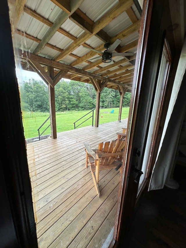 deck with ceiling fan and a yard