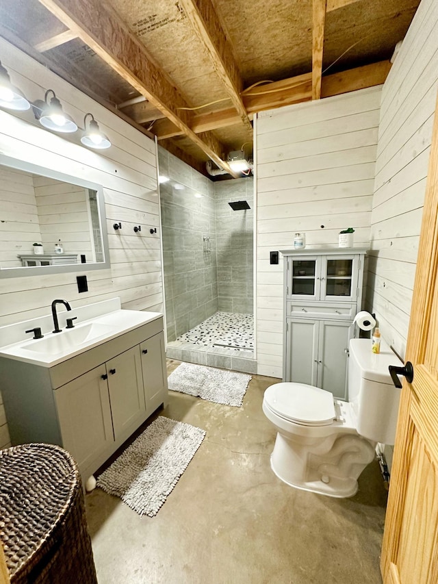 bathroom featuring vanity, wood walls, walk in shower, and concrete floors