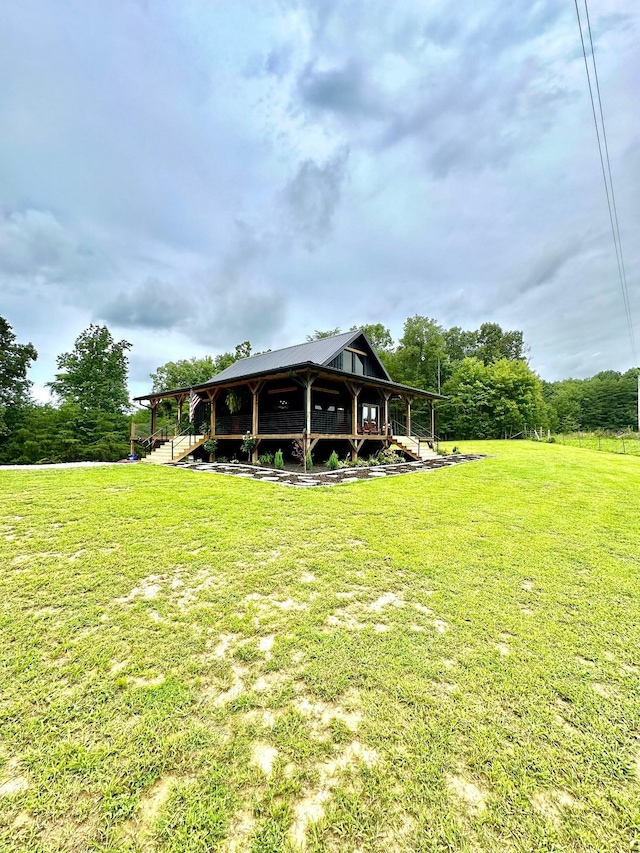 rear view of property featuring a lawn