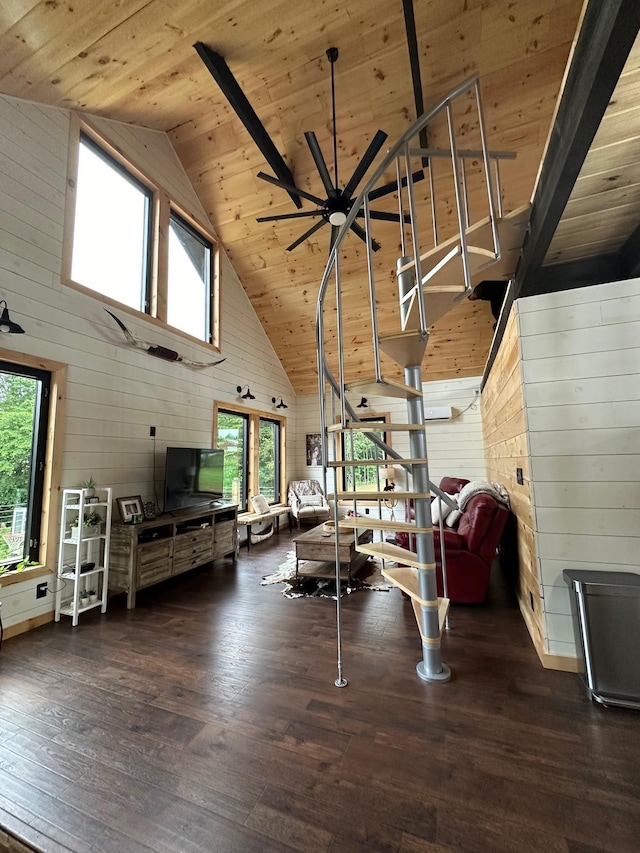 unfurnished living room with wooden walls, dark hardwood / wood-style floors, high vaulted ceiling, and wooden ceiling