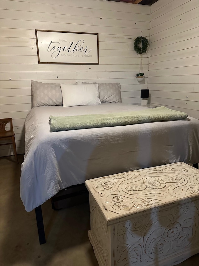 bedroom featuring wooden walls