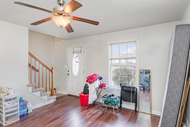 foyer entrance with ceiling fan and dark hardwood / wood-style floors