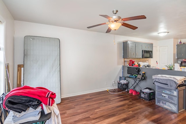 interior space featuring ceiling fan and dark wood-type flooring