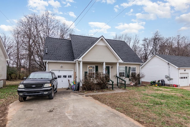 view of front of house with a porch, a garage, and a front lawn