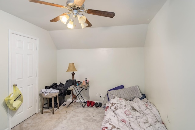 bedroom featuring light colored carpet, vaulted ceiling, and ceiling fan