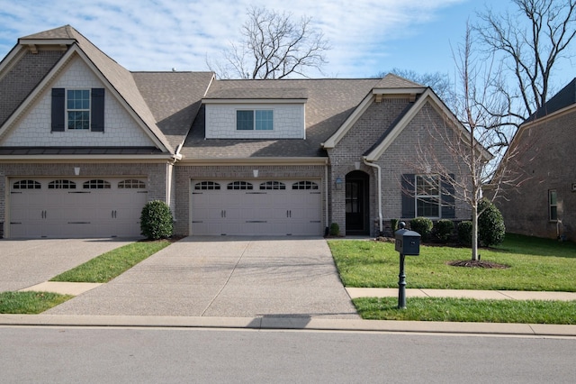 view of front of property featuring a garage and a front lawn