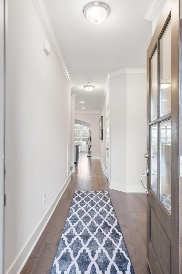 hall with dark hardwood / wood-style flooring and crown molding