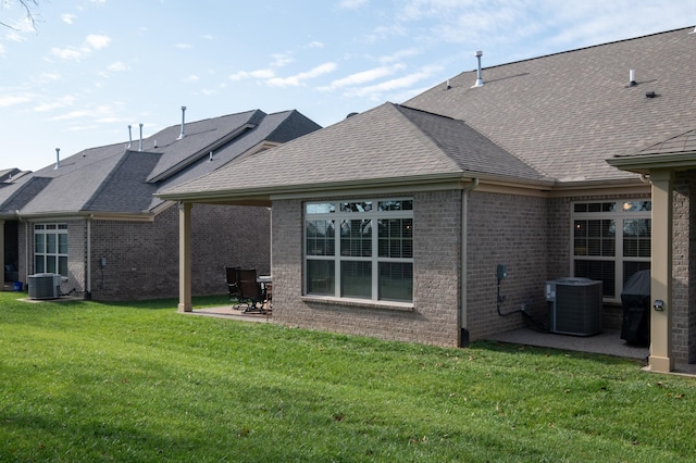 back of house featuring a lawn, a patio, and central AC