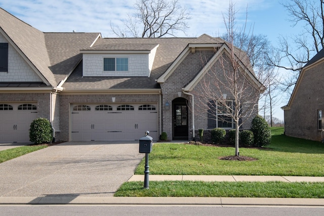 view of front of property featuring a garage and a front lawn