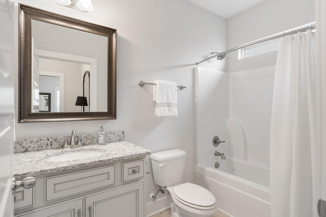 full bathroom with vanity, shower / tub combo, and toilet