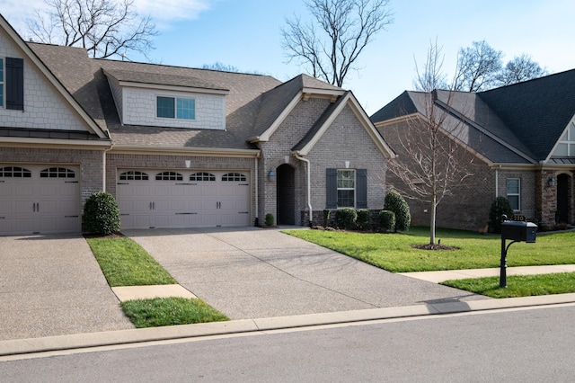 view of front of property featuring a garage and a front lawn