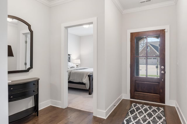 foyer entrance featuring ornamental molding, dark wood-type flooring, and a wealth of natural light