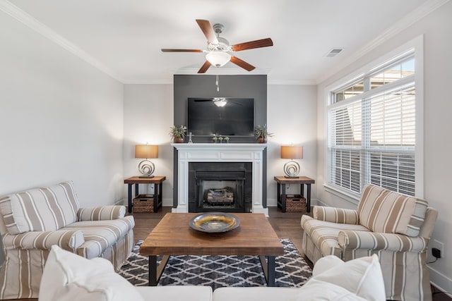 living room with hardwood / wood-style flooring, ceiling fan, and crown molding