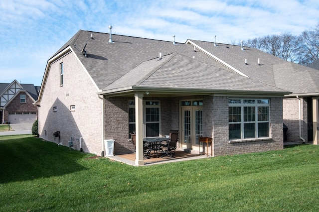 rear view of house with a lawn and a patio area