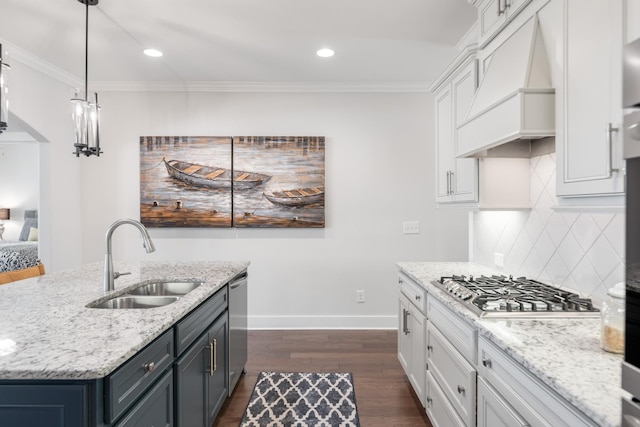 kitchen featuring white cabinets, decorative backsplash, ornamental molding, and sink