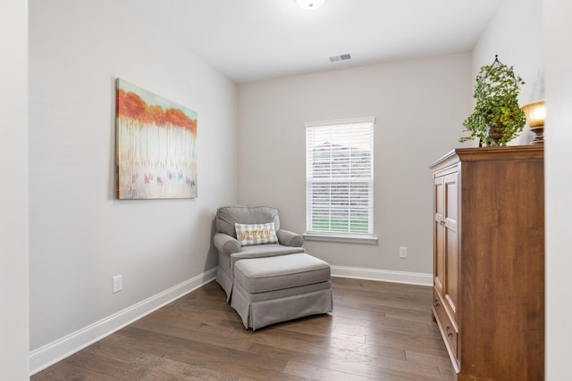 sitting room featuring dark wood-type flooring