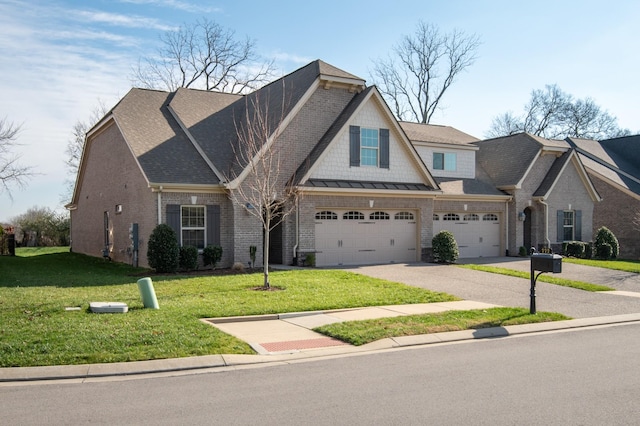 view of front of home with a garage and a front lawn