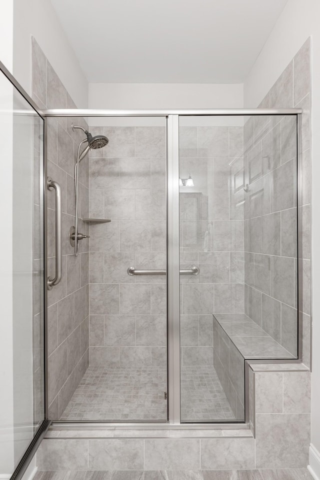 bathroom featuring a shower with shower door