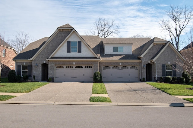 view of front of property featuring a garage and a front lawn