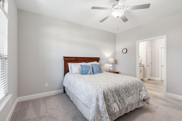 carpeted bedroom with ceiling fan and ensuite bathroom