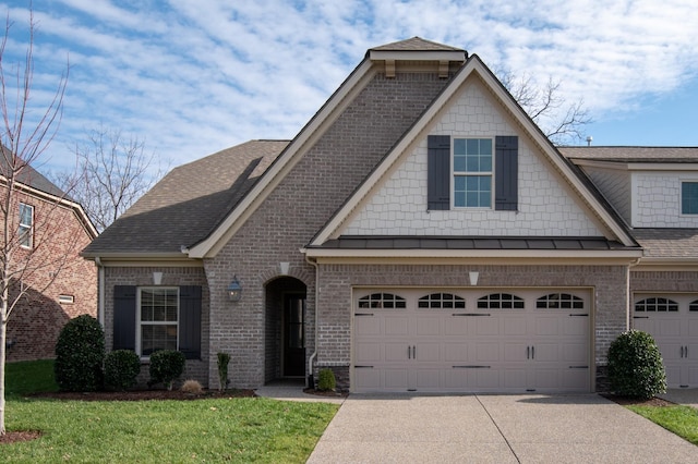 craftsman inspired home with a garage and a front lawn