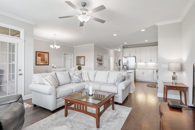 living room featuring crown molding, dark hardwood / wood-style flooring, and ceiling fan with notable chandelier