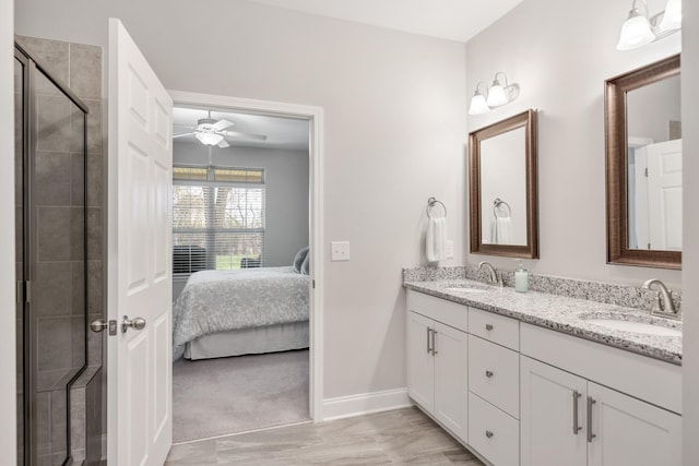 bathroom featuring an enclosed shower, vanity, and ceiling fan