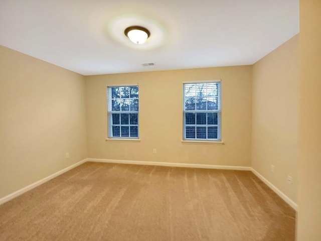 unfurnished room with light colored carpet