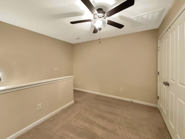 empty room with light carpet and ceiling fan