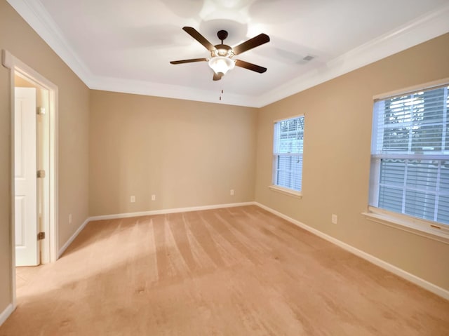 empty room featuring ceiling fan, plenty of natural light, and crown molding