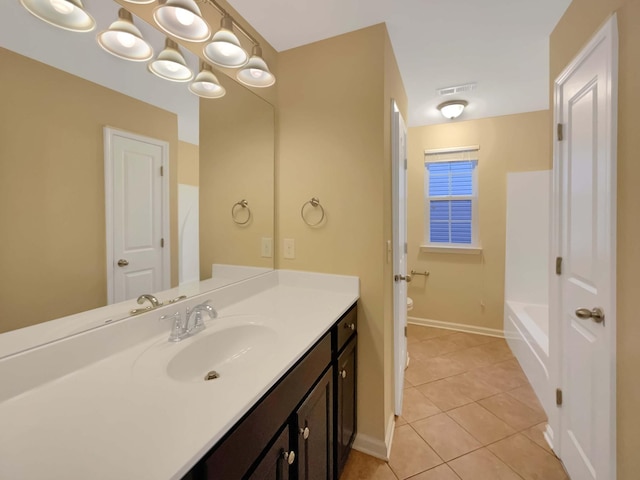 bathroom with tile patterned flooring, vanity, and toilet