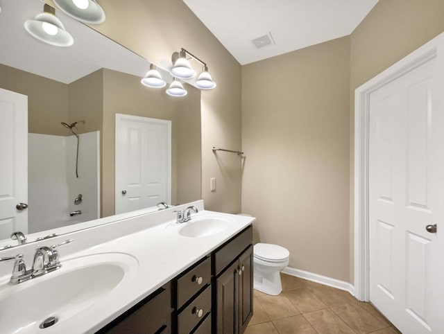 full bathroom featuring tile patterned flooring, bathtub / shower combination, vanity, and toilet