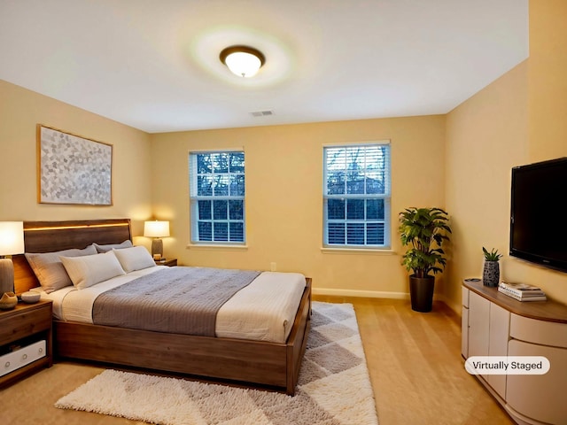 bedroom with light colored carpet