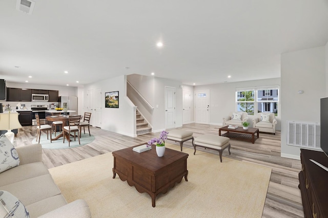 living room with light hardwood / wood-style flooring