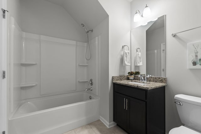 full bathroom featuring vanity,  shower combination, vaulted ceiling, tile patterned flooring, and toilet