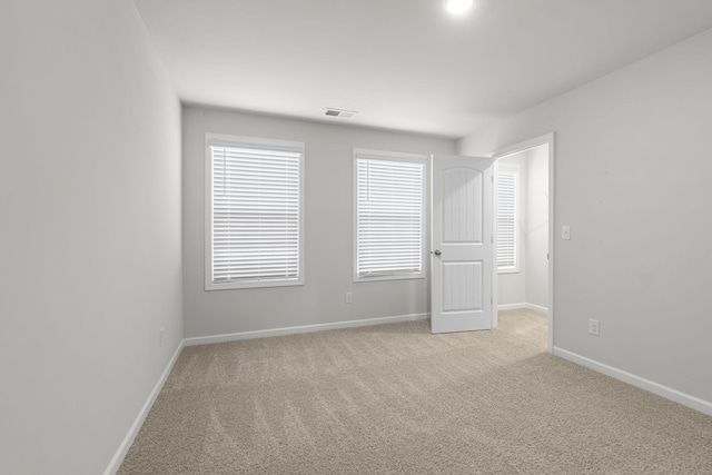 unfurnished room with light carpet