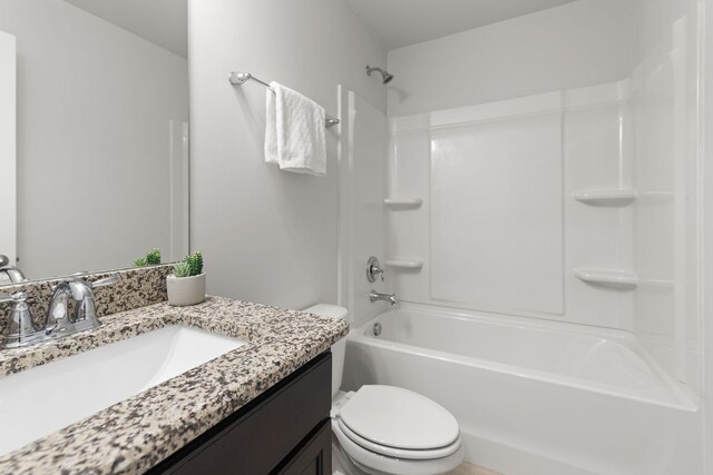 full bathroom with vanity, bathing tub / shower combination, and toilet