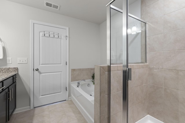 bathroom with plus walk in shower, tile patterned flooring, and vanity