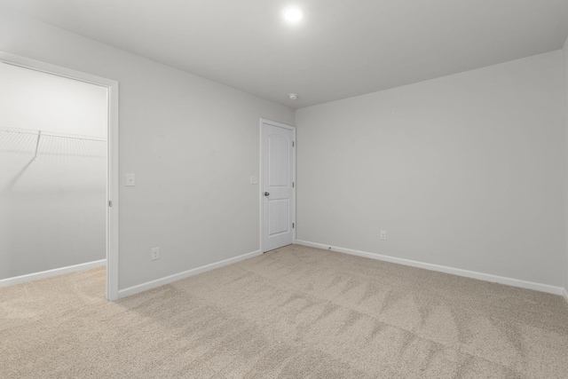 unfurnished room featuring light colored carpet