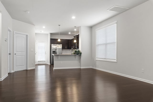 unfurnished living room featuring dark hardwood / wood-style flooring