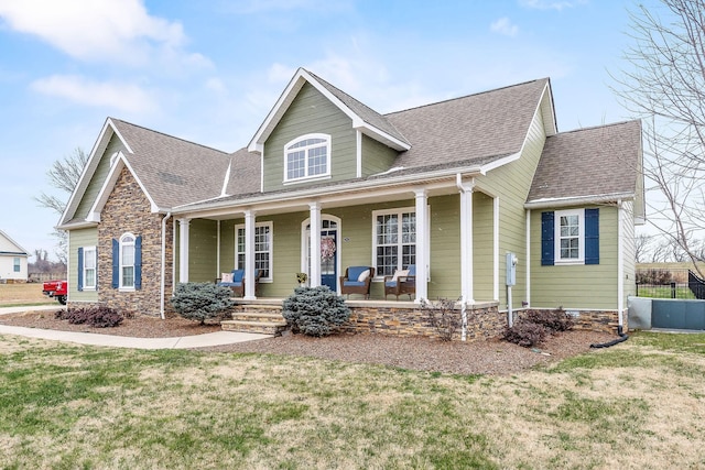 view of front of house with covered porch and a front lawn