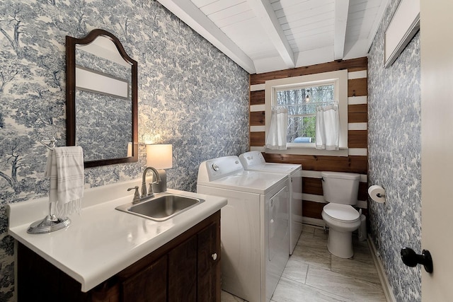 laundry room featuring washing machine and dryer, sink, and wooden ceiling