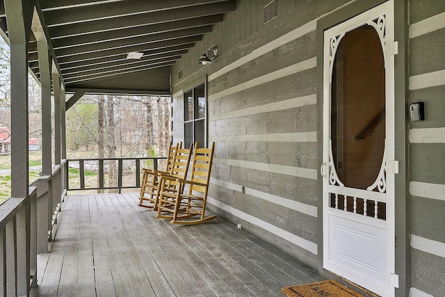 wooden terrace with a porch