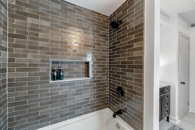 bathroom featuring vanity and tiled shower / bath combo